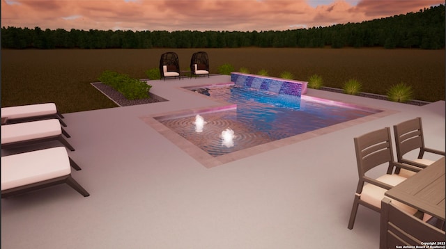 patio terrace at dusk featuring pool water feature