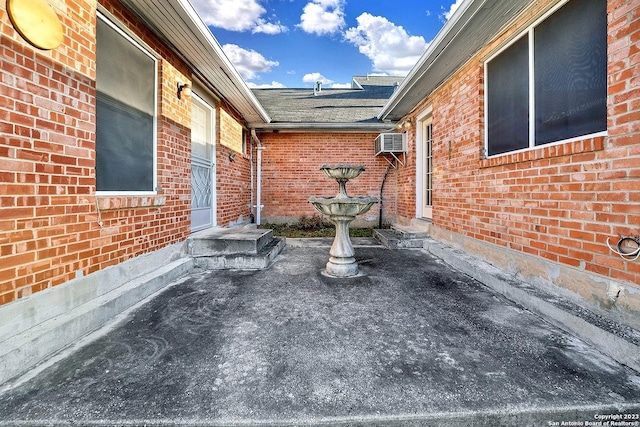 view of patio featuring an AC wall unit