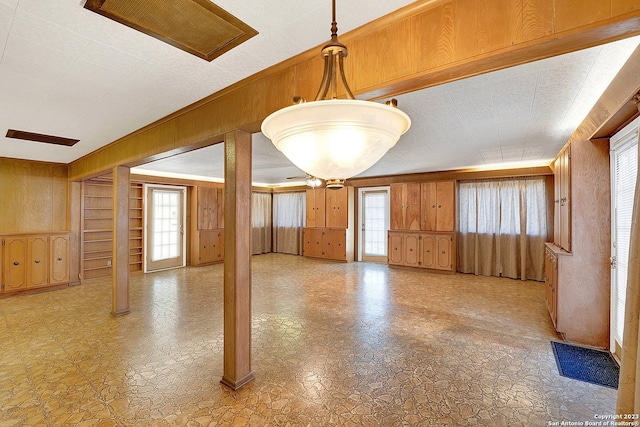 interior space with plenty of natural light and wood walls