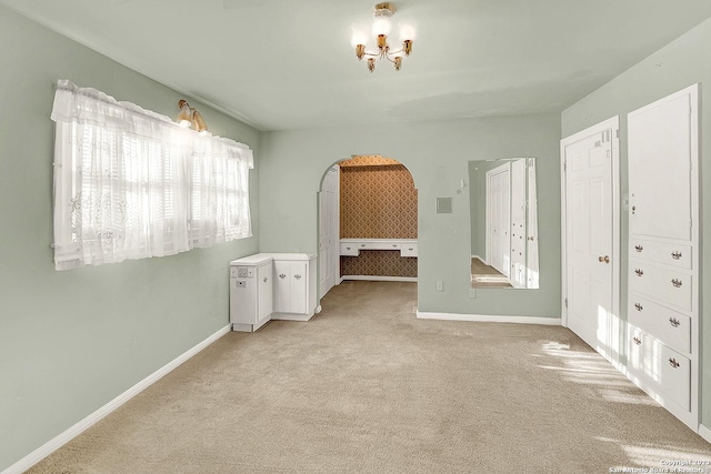 unfurnished bedroom featuring light carpet