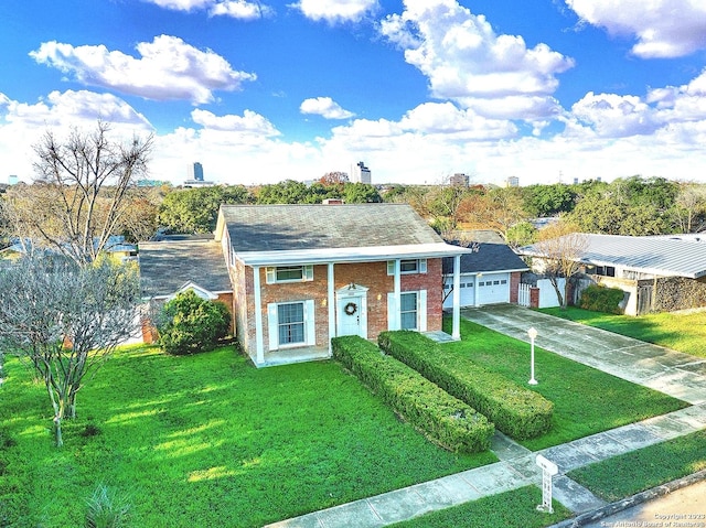 view of front of home with a garage and a front lawn