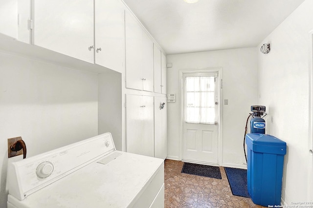 washroom featuring washer / dryer and cabinets