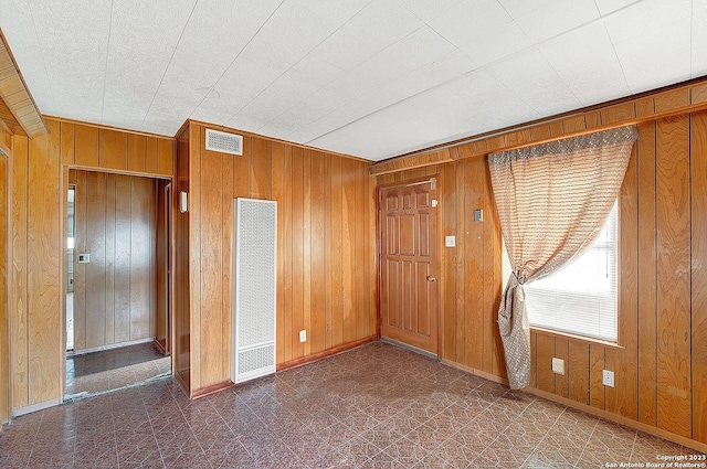 unfurnished bedroom with wooden walls and a closet