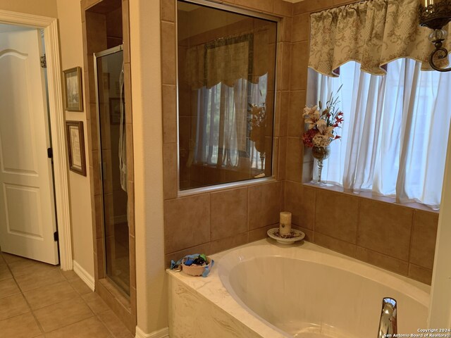 bathroom with tile patterned flooring and plus walk in shower