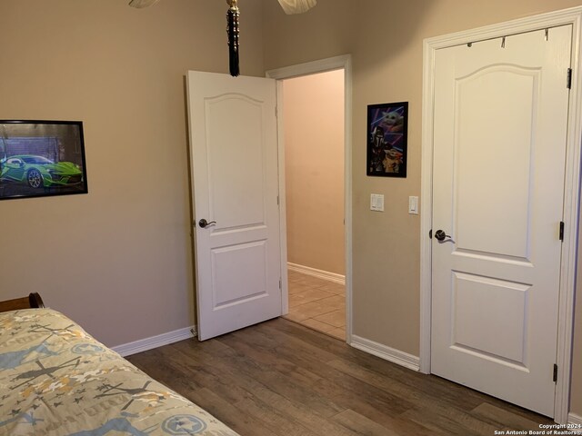 bedroom with dark hardwood / wood-style flooring