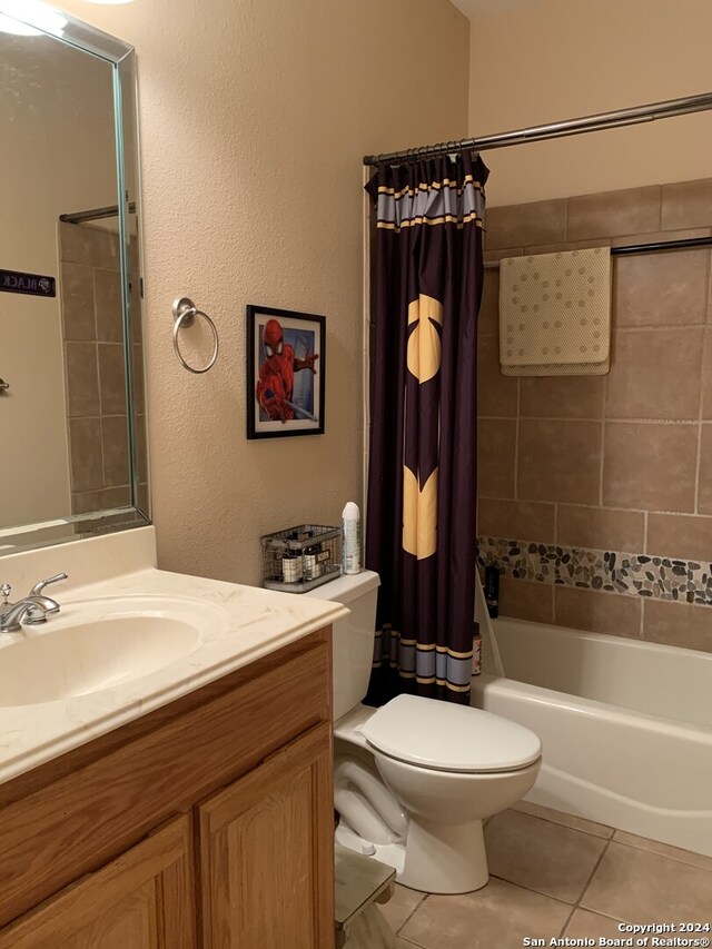 full bathroom with tile patterned floors, vanity, toilet, and shower / bathtub combination with curtain