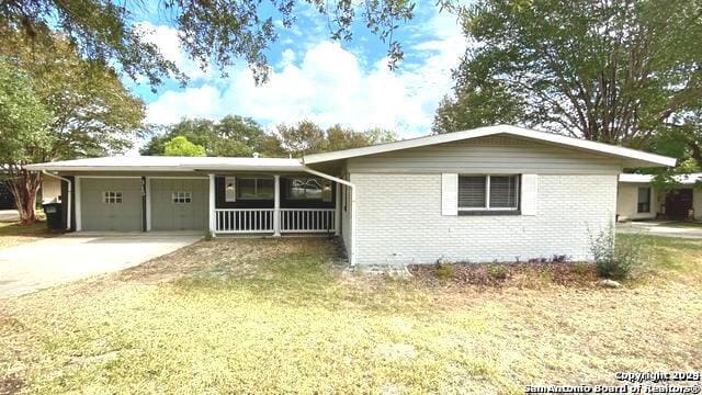 single story home featuring a garage and a front lawn