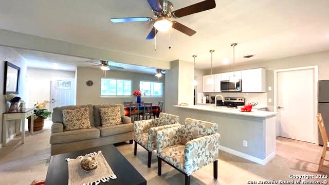 living room with ceiling fan