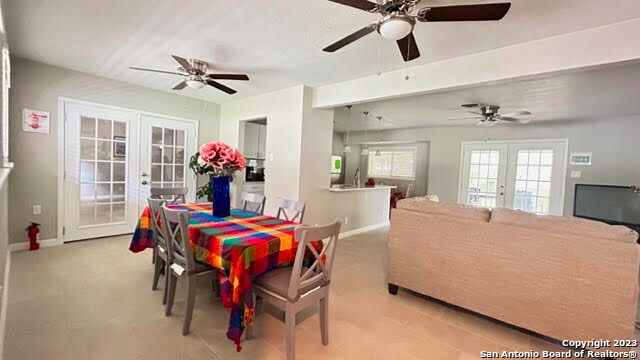 dining space with french doors and ceiling fan