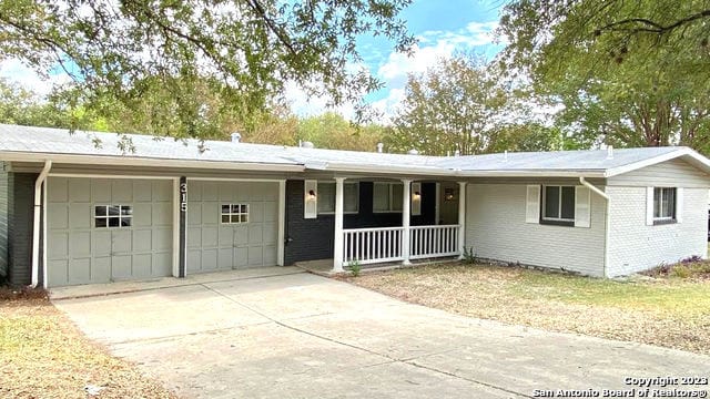 single story home with a garage and a porch