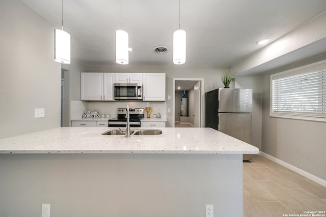 kitchen with stainless steel appliances, white cabinets, decorative light fixtures, light stone countertops, and light tile patterned flooring