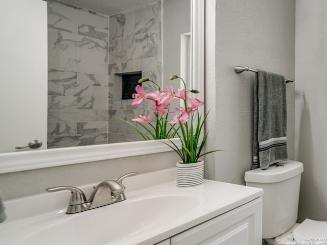 bathroom featuring toilet and vanity