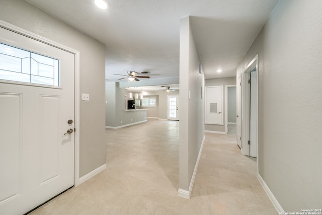 tiled entryway with ceiling fan