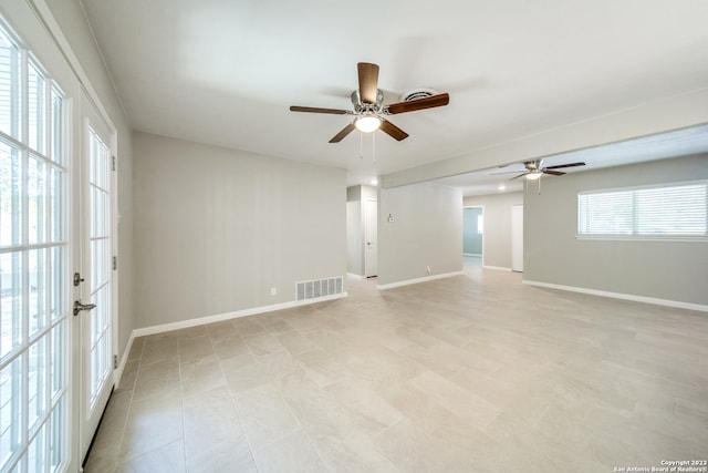 tiled empty room with french doors and ceiling fan