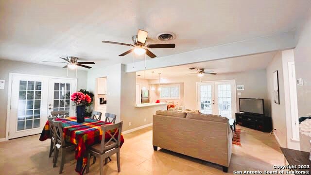 dining space with french doors and ceiling fan