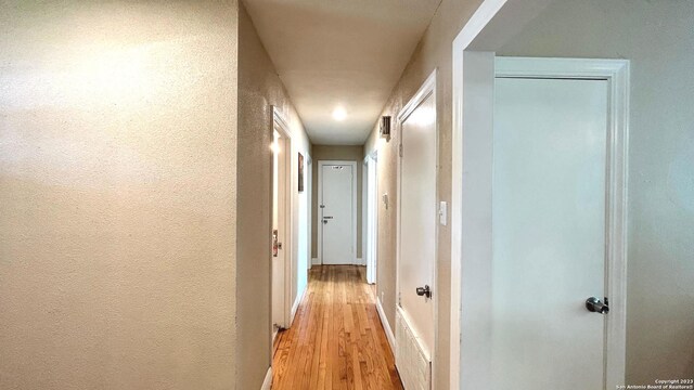 hall with light hardwood / wood-style floors