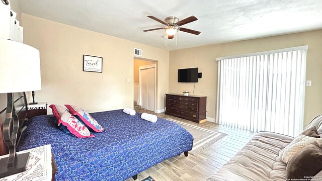 bedroom with light wood-type flooring and ceiling fan