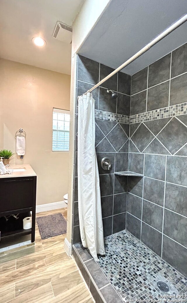 bathroom with vanity, a shower with curtain, and toilet