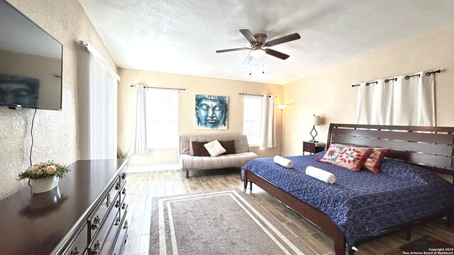 bedroom featuring ceiling fan and hardwood / wood-style flooring