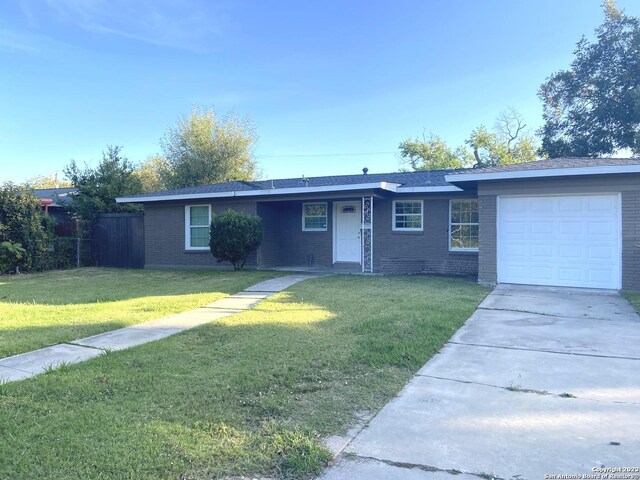 ranch-style home with a garage and a front lawn