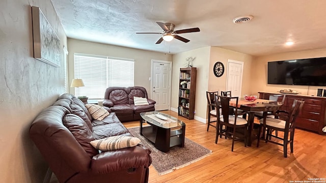 living room with ceiling fan and light hardwood / wood-style floors