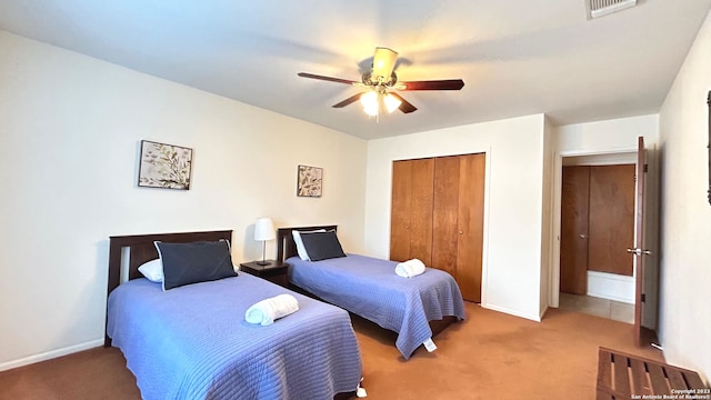 bedroom with a closet, ceiling fan, and carpet floors