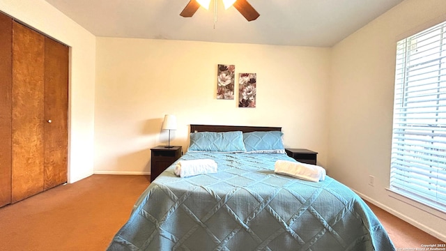 bedroom with a closet, ceiling fan, and carpet floors