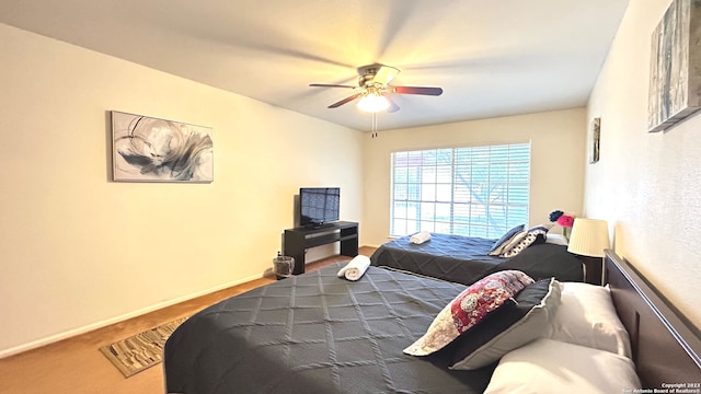 bedroom with ceiling fan and carpet flooring