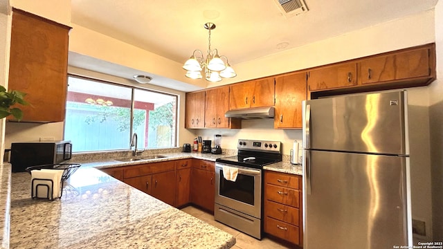 kitchen with hanging light fixtures, stainless steel appliances, a chandelier, sink, and light tile patterned flooring