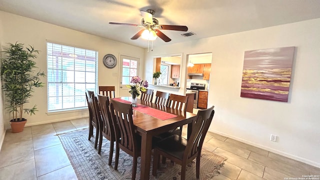 dining area with a healthy amount of sunlight, ceiling fan, and light tile patterned flooring