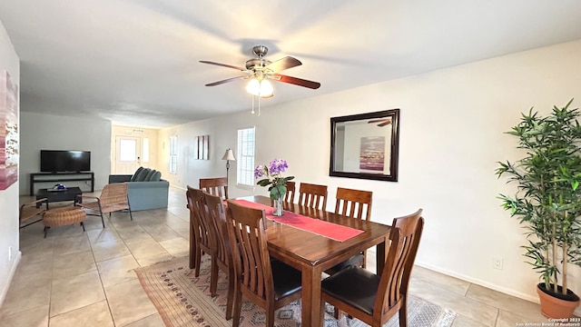 tiled dining room featuring ceiling fan