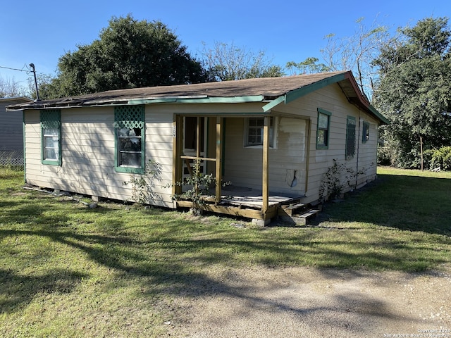 back of property with a lawn