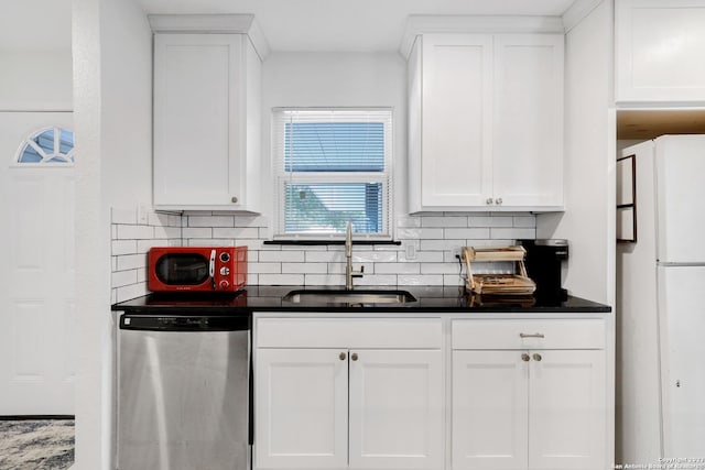 kitchen with sink, dishwasher, backsplash, white cabinets, and white fridge