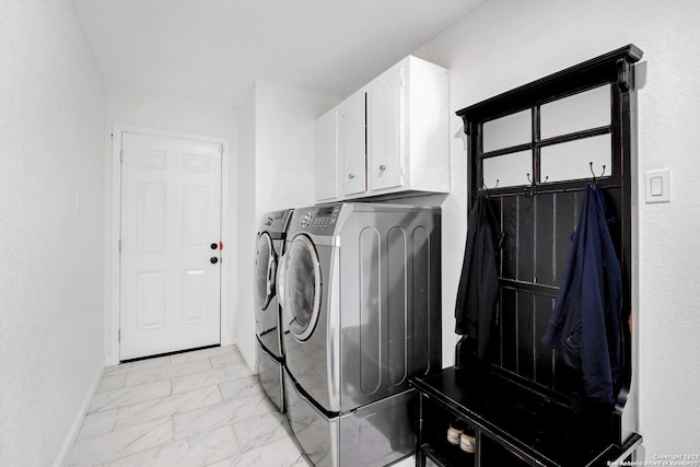 laundry area featuring cabinets and washing machine and clothes dryer