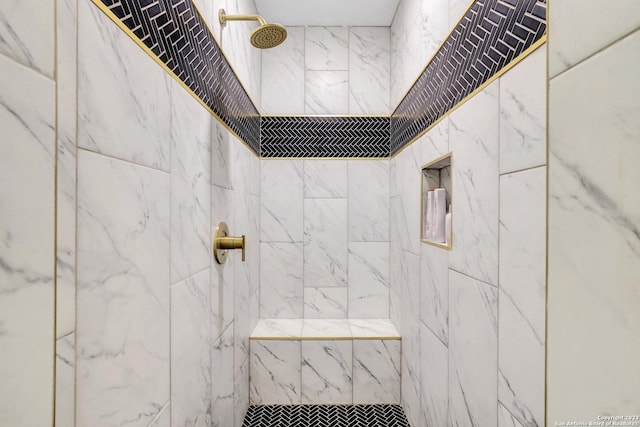 bathroom with tiled shower