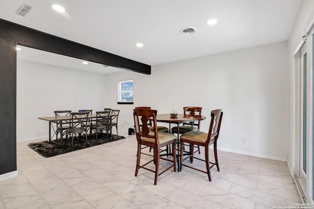 dining space with beamed ceiling