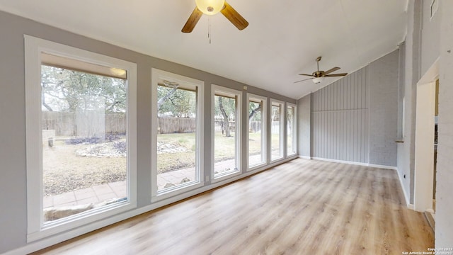 unfurnished sunroom featuring lofted ceiling and ceiling fan