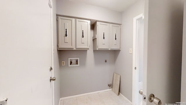 washroom with cabinets, hookup for a washing machine, and hookup for an electric dryer