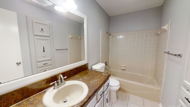 full bathroom with vanity, tiled shower / bath combo, tile patterned floors, and toilet