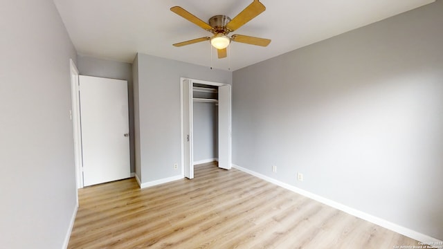 unfurnished bedroom with light hardwood / wood-style flooring, ceiling fan, and a closet