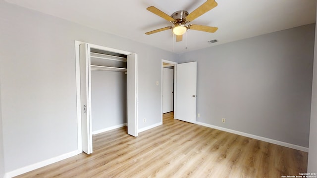 unfurnished bedroom featuring ceiling fan, light hardwood / wood-style floors, and a closet