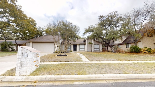 view of front of home featuring a garage and a front lawn