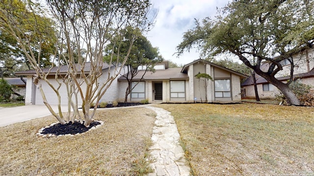 view of front of property featuring a garage and a front lawn