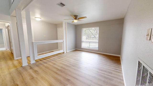 empty room with ceiling fan and light wood-type flooring