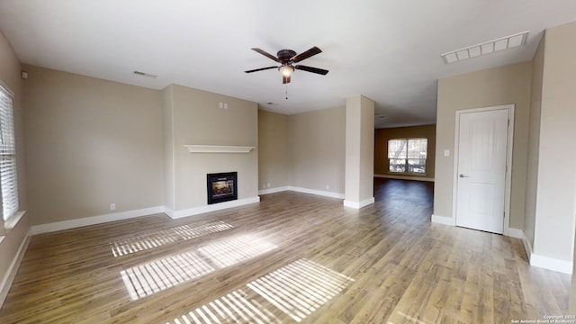 unfurnished living room with ceiling fan and light wood-type flooring