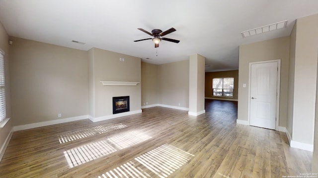 unfurnished living room with ceiling fan and light wood-type flooring