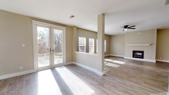 unfurnished living room featuring hardwood / wood-style floors, french doors, and ceiling fan