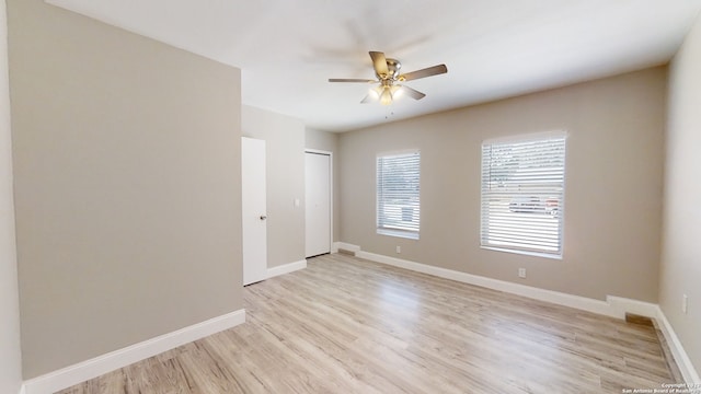 spare room featuring ceiling fan and light wood-type flooring