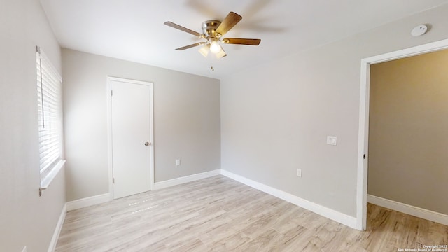 spare room featuring plenty of natural light, ceiling fan, and light hardwood / wood-style flooring