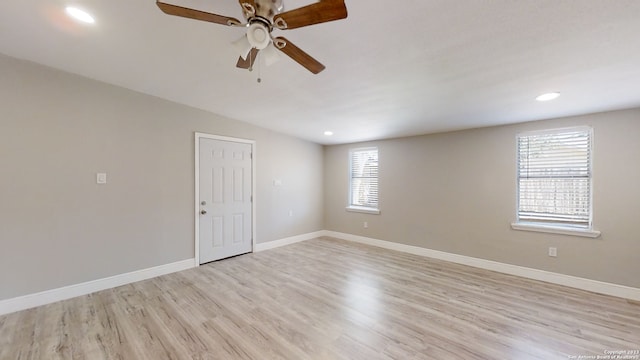 empty room featuring ceiling fan and light hardwood / wood-style floors